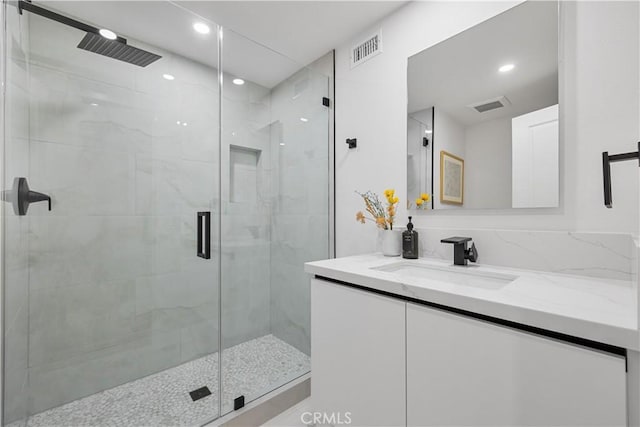 bathroom with an enclosed shower and vanity