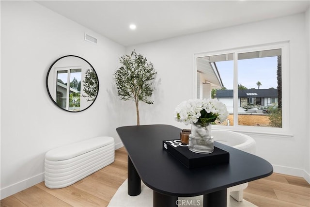 dining space with hardwood / wood-style flooring and a wealth of natural light