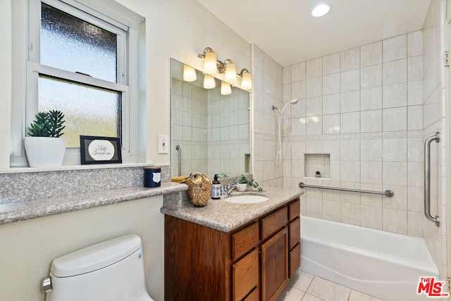 full bathroom with vanity, toilet, tiled shower / bath combo, and tile patterned flooring