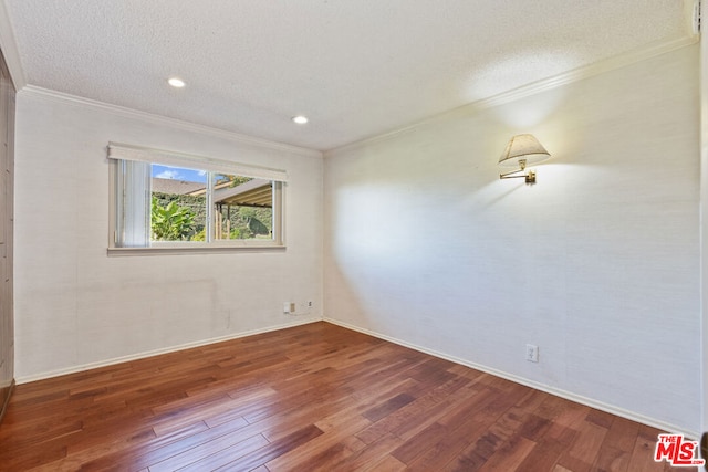 empty room featuring hardwood / wood-style flooring, a textured ceiling, and crown molding