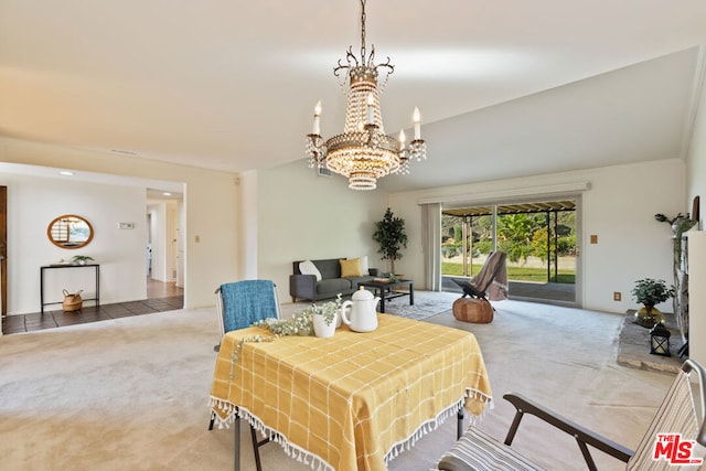 dining area featuring carpet flooring and an inviting chandelier