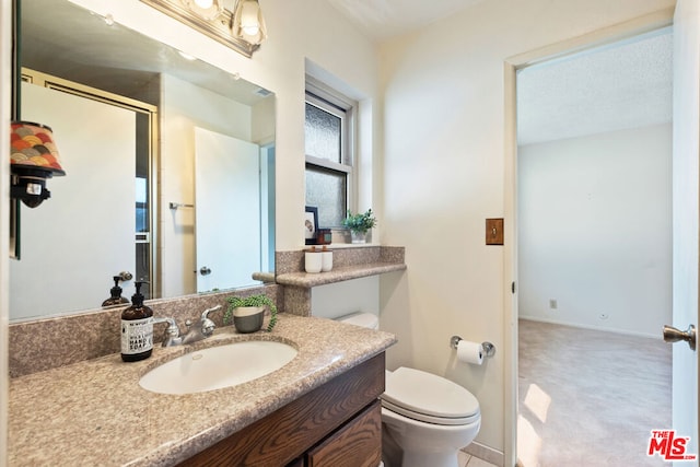 bathroom featuring toilet and vanity