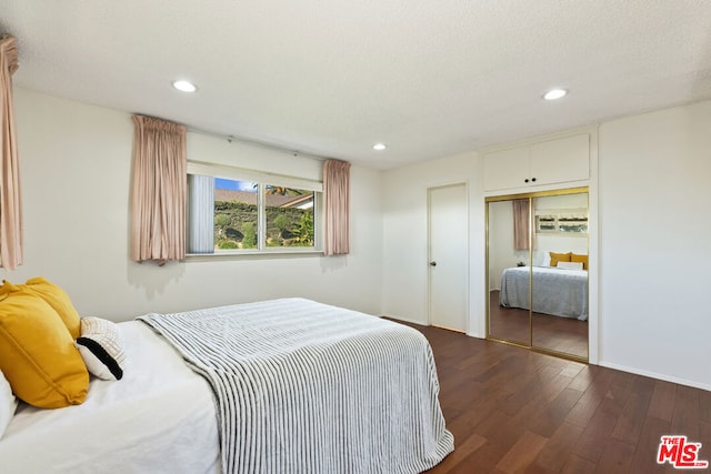 bedroom featuring a closet and dark hardwood / wood-style flooring