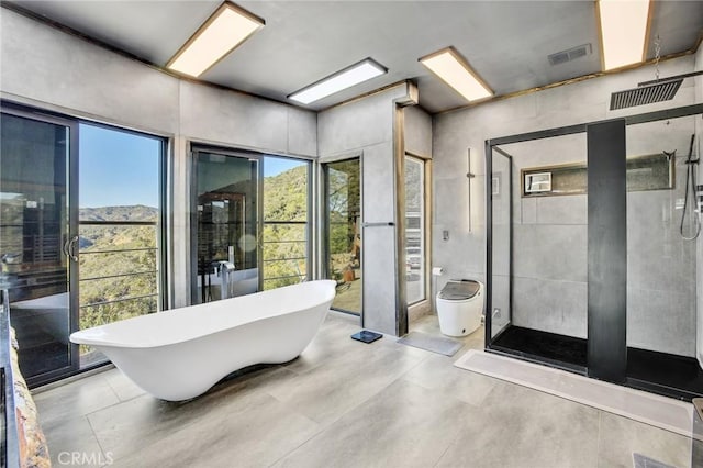 bathroom with a mountain view and shower with separate bathtub