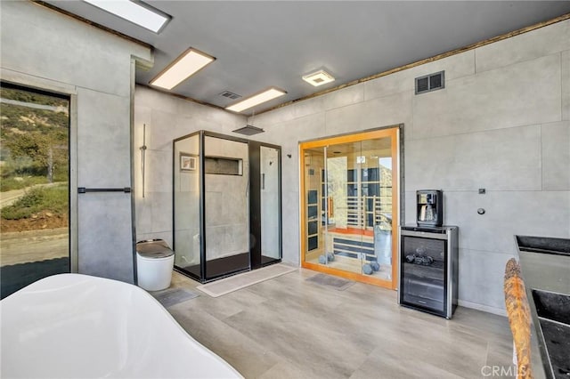 bathroom featuring concrete flooring and plus walk in shower