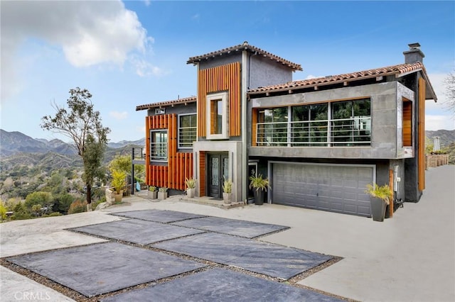 view of front of property featuring a garage and a mountain view