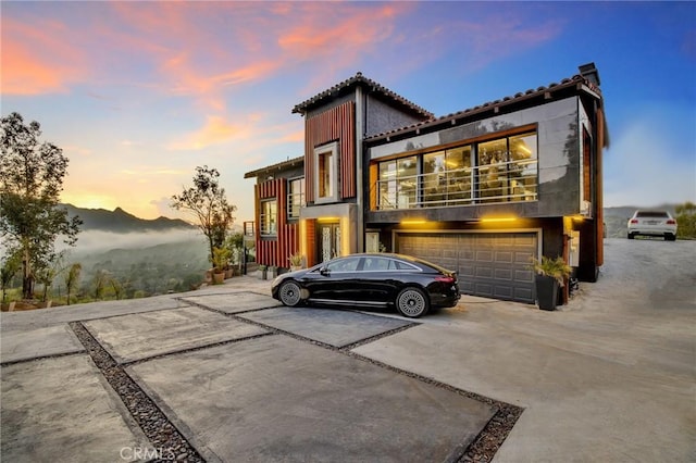 view of front of home with a mountain view and a garage