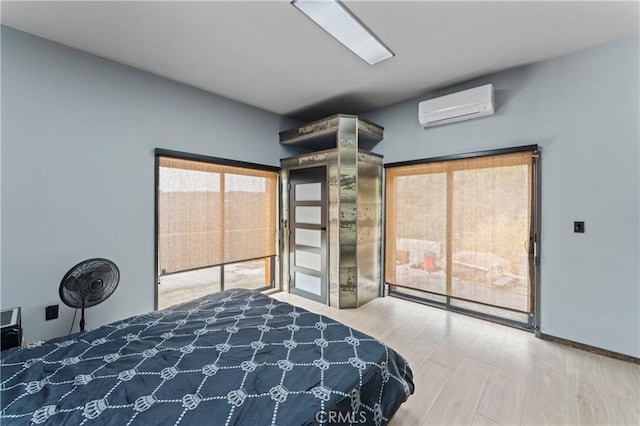 bedroom with wood-type flooring and a wall unit AC