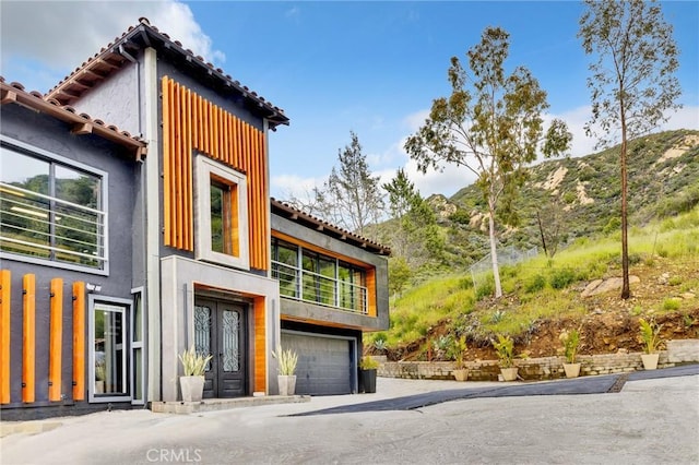 view of home's exterior featuring a mountain view and a garage