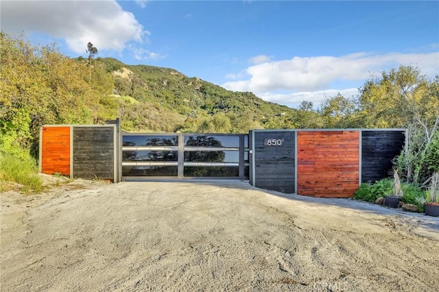 view of gate featuring a mountain view