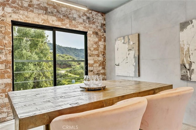 dining space featuring a mountain view and bar area