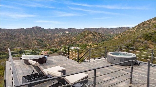 wooden terrace with a mountain view and a hot tub