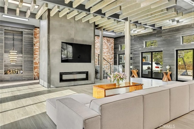 interior space with a high ceiling and light hardwood / wood-style flooring