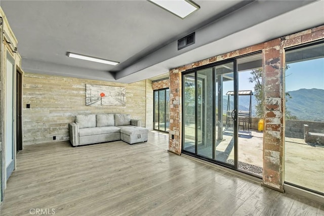 unfurnished living room featuring a mountain view and hardwood / wood-style floors