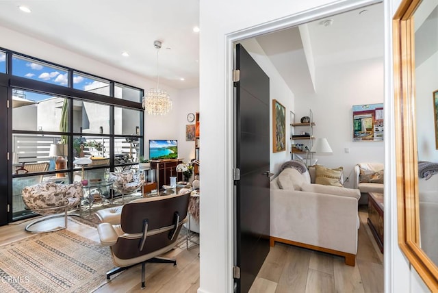 interior space with light hardwood / wood-style floors and an inviting chandelier