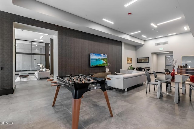 recreation room featuring concrete floors