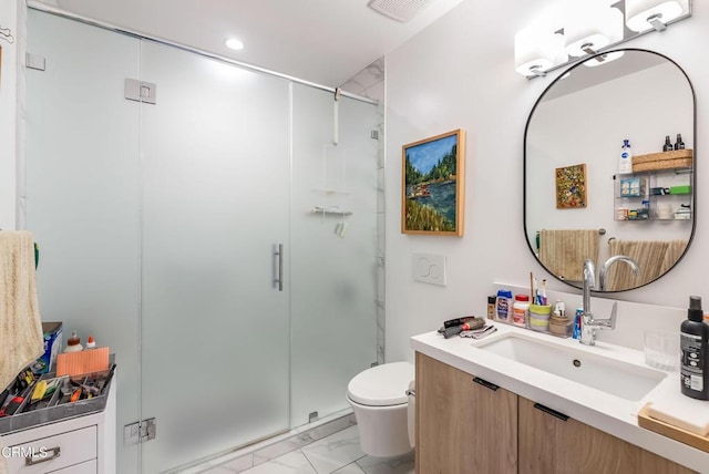 bathroom featuring toilet, a shower with shower door, and vanity