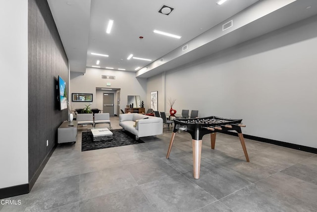 rec room with concrete flooring