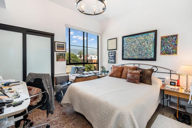 bedroom featuring a chandelier and hardwood / wood-style floors