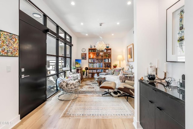 sitting room featuring light hardwood / wood-style floors and an inviting chandelier