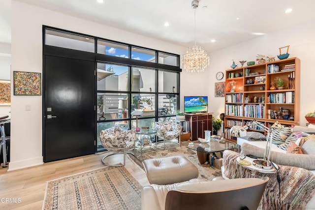 living room with an inviting chandelier and light hardwood / wood-style floors