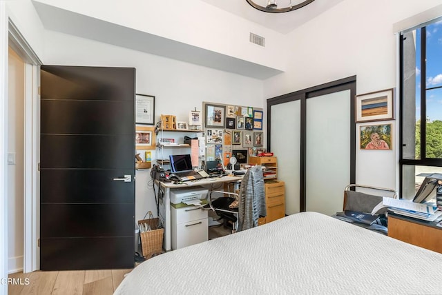 bedroom with a closet and light hardwood / wood-style floors