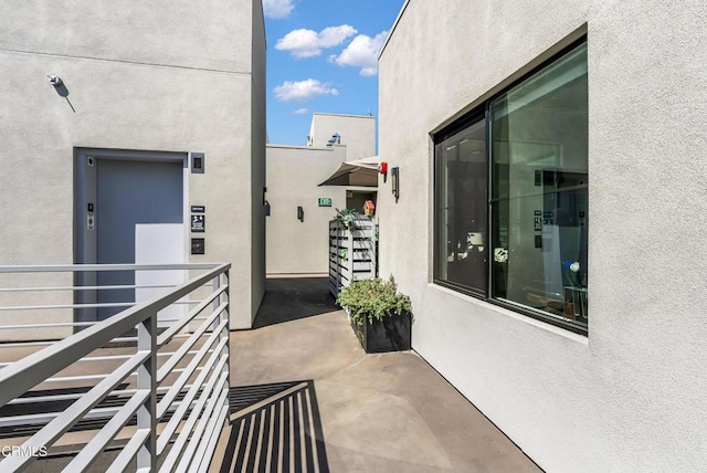 exterior space featuring elevator and a balcony