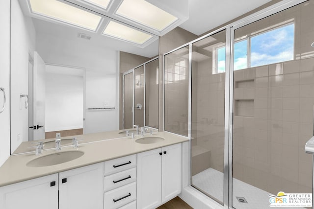 bathroom with an enclosed shower and vanity