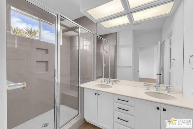 bathroom with an enclosed shower and vanity