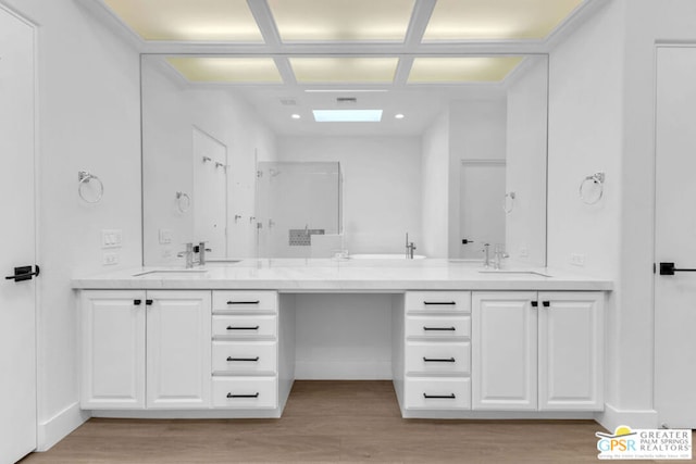 bathroom with hardwood / wood-style flooring and vanity