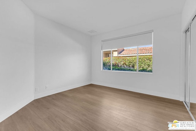 spare room with wood-type flooring