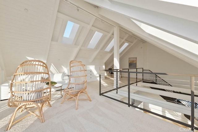 additional living space featuring carpet floors and lofted ceiling with skylight