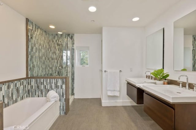 bathroom with vanity and independent shower and bath