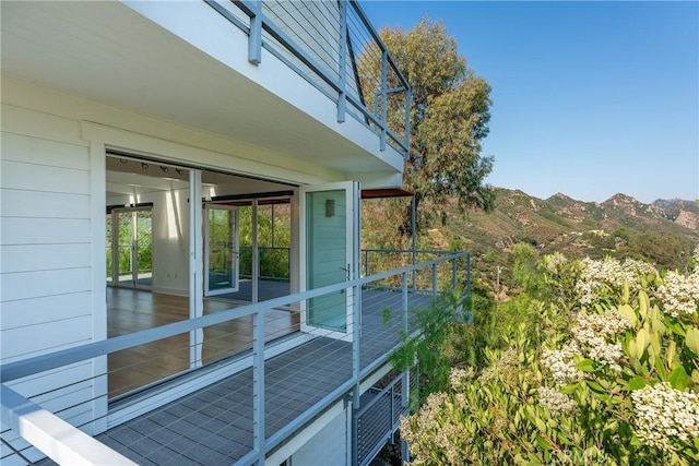 view of side of home with a balcony and a mountain view