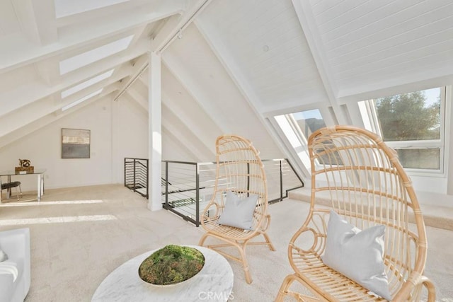 interior space featuring lofted ceiling with skylight