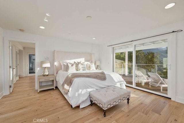 bedroom with access to exterior and light wood-type flooring