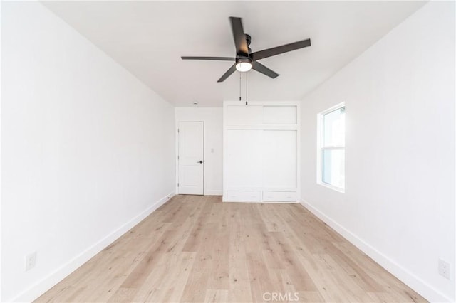 spare room featuring light wood-type flooring and ceiling fan