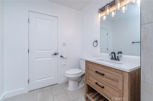 bathroom with toilet, tile patterned floors, and vanity