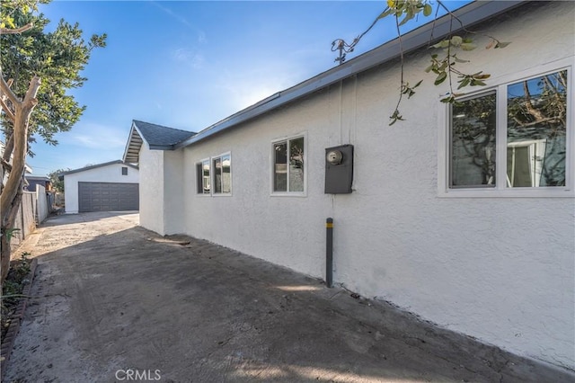 view of side of property with a garage and an outdoor structure