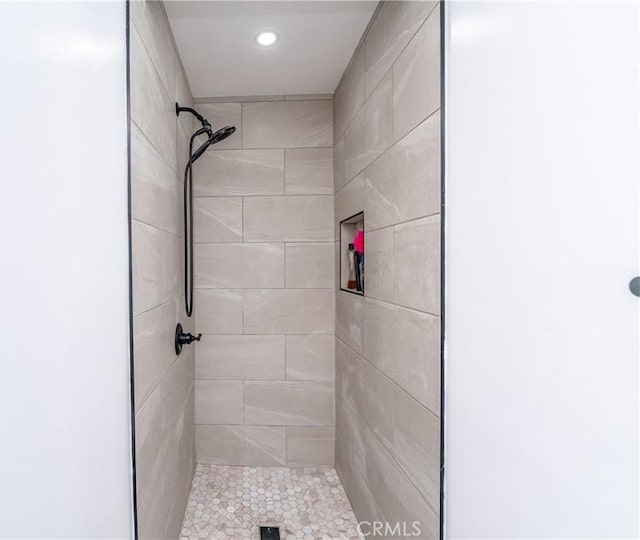 bathroom with a tile shower