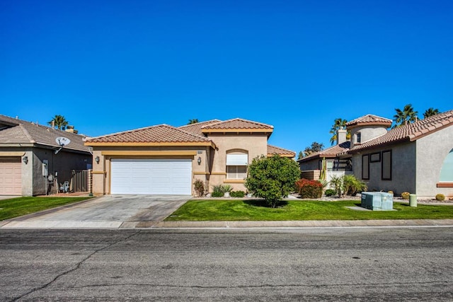 mediterranean / spanish-style house featuring a garage and a front yard