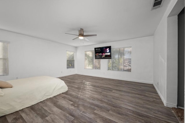 unfurnished bedroom featuring ceiling fan and dark hardwood / wood-style flooring