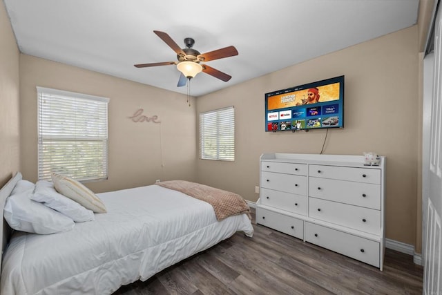 bedroom with ceiling fan and dark wood-type flooring