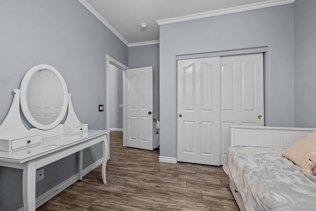 bedroom featuring a closet, crown molding, and wood-type flooring