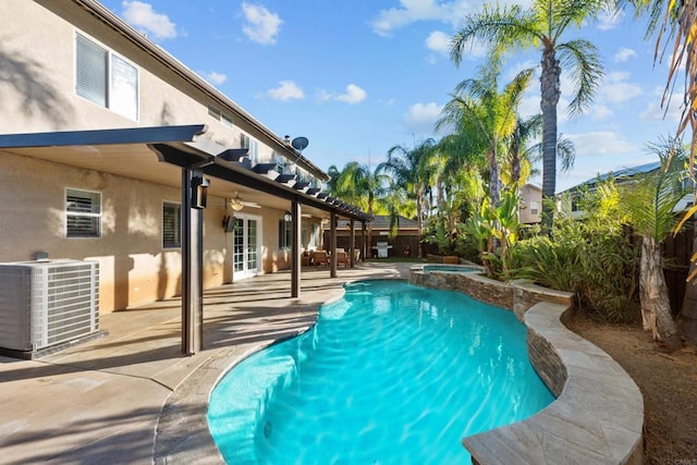 view of swimming pool with an in ground hot tub, central AC unit, and a patio