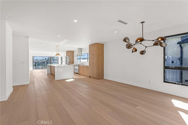 interior space with light wood-type flooring and an inviting chandelier