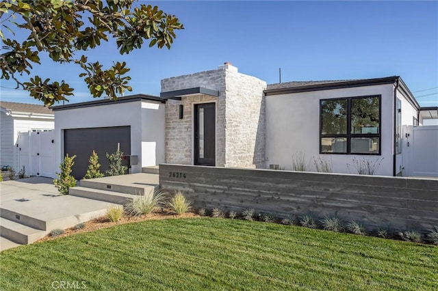 contemporary house featuring a garage and a front yard