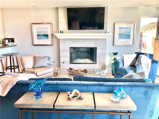 living room with a tiled fireplace