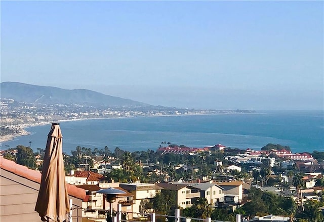 exterior space with a water and mountain view