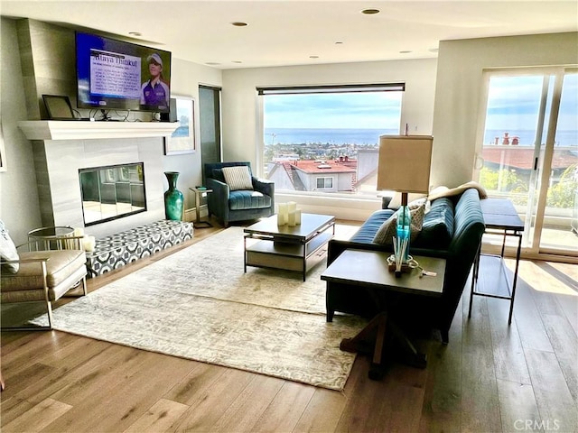 24400 Alta Vista Dr, Dana Point, CA 92629 - living area with wood-type flooring, plenty of natural light, a tile fireplace, and recessed lighting
